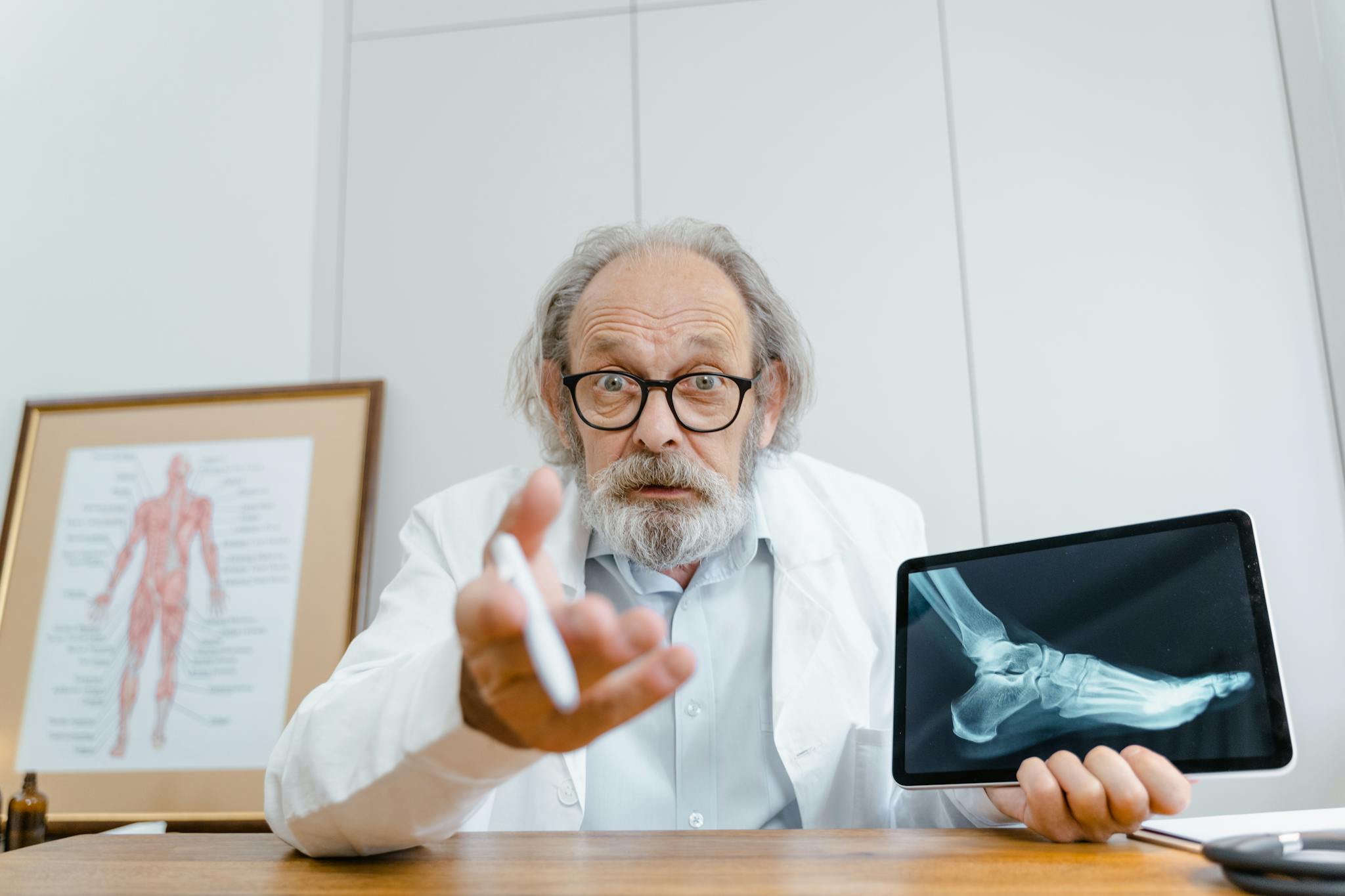 FAQ Senior Doctor Showing Patients X Ray On A